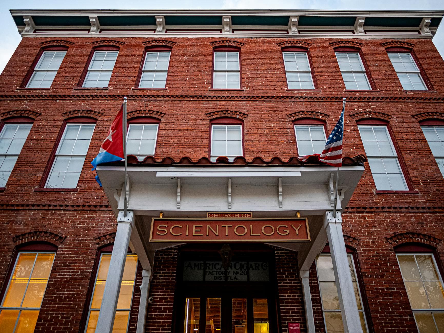 Low-angle view of a historic Scientology building in Tampa, Florida, showcasing its architectural facade.