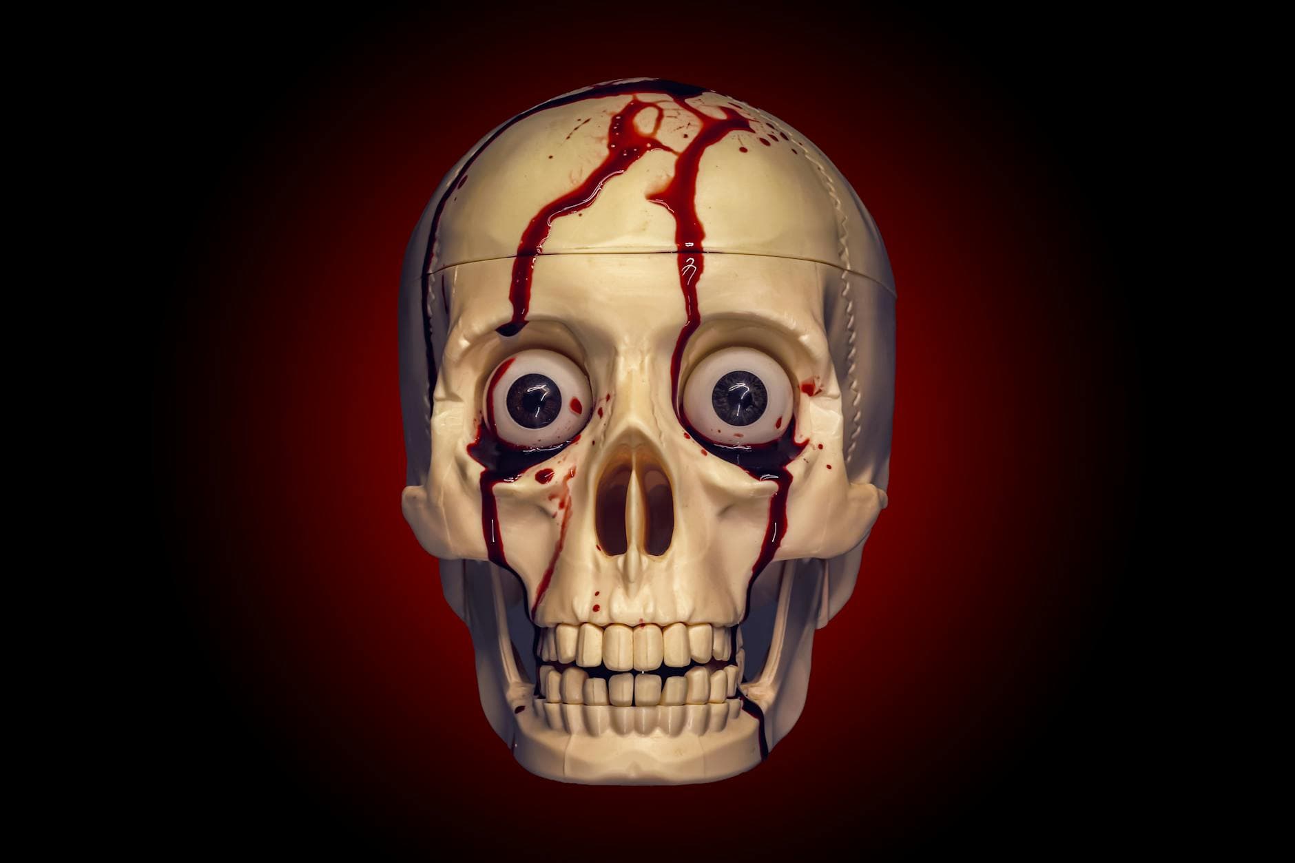 Realistic skull with creepy eyes and blood trickling, perfect for horror themes.