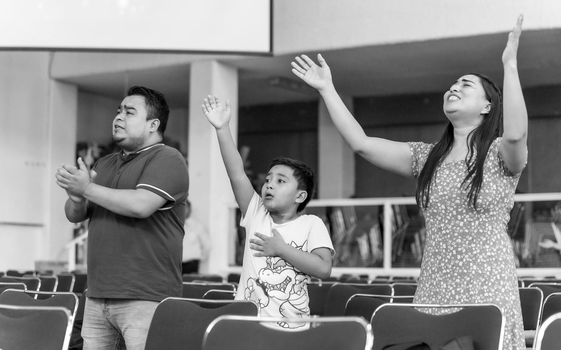 A family passionately engaged in prayer at a church in Mexico City.