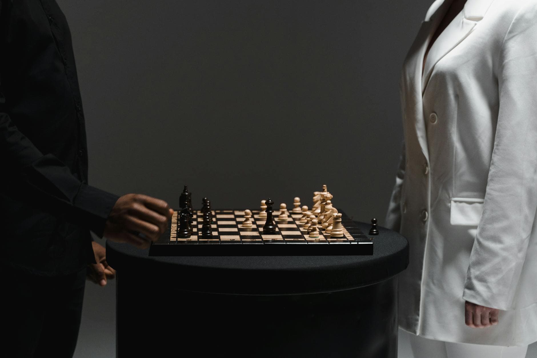 Two individuals engaged in a strategic chess match, demonstrating concentration and tactics.